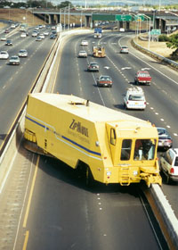 HDOT's yellow Zipmobile, turning the eastbound zipper lane back into two westbound regular lanes