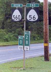 Begin sign for route 560 with zero milepost, alongside end sign for route 56 with terminal milepost underneath