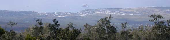 Scenic view of coast around Kailua-Kona, including cruise ship anchored offshore, from Kaloko Drive high on the west slope of the Hualalai volcano