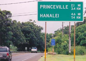 Sign on route 56, indicating distances to Princeville and Hanalei, in both miles and kilometers