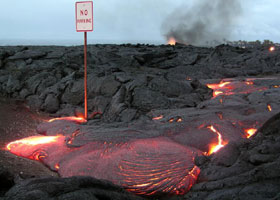 'No parking' sign with lava flowing around the signpost onto the pavement beneath