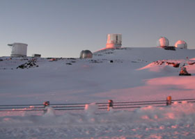 Five telescopes atop the snow-covered summit